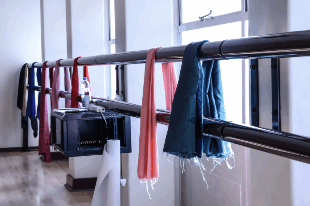 colourful scarves draped along the ballet barres in the workshop venue